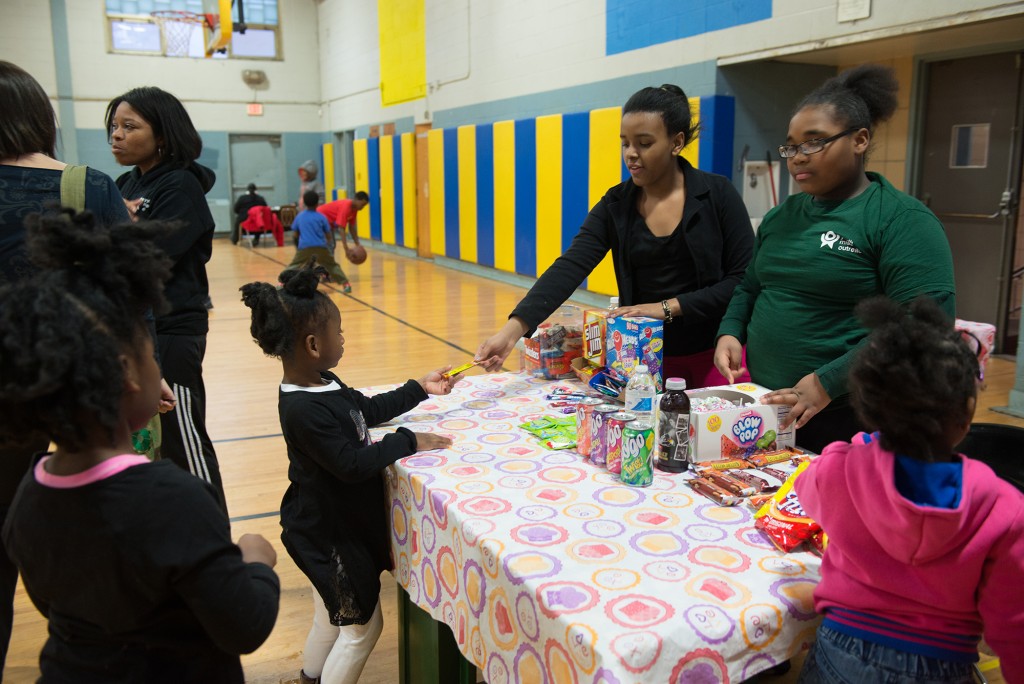 Angel Henderson (left), 12, and Loquanis Keys, 11, man the Kids' Corner snack bar at Youth Night, which helps them sharpen their entrepreneurial and customer service skills.