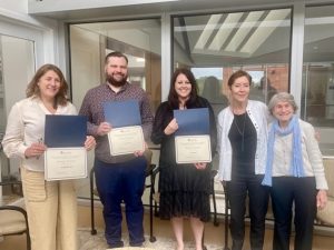 A group of faculty members stand together with their Excellence Awards from the College of Liberal Arts & Sciences