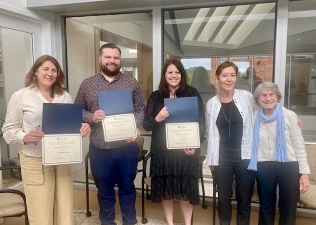 A group of faculty members stand together with their Excellence Awards from the College of Liberal Arts & Sciences