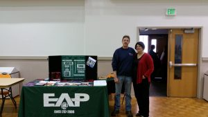 The EAP Table with Doug and MaryAlice providing useful information and free reusable shopping bags. 