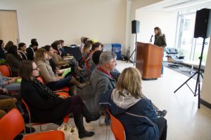 picture of student reading their submission with audience